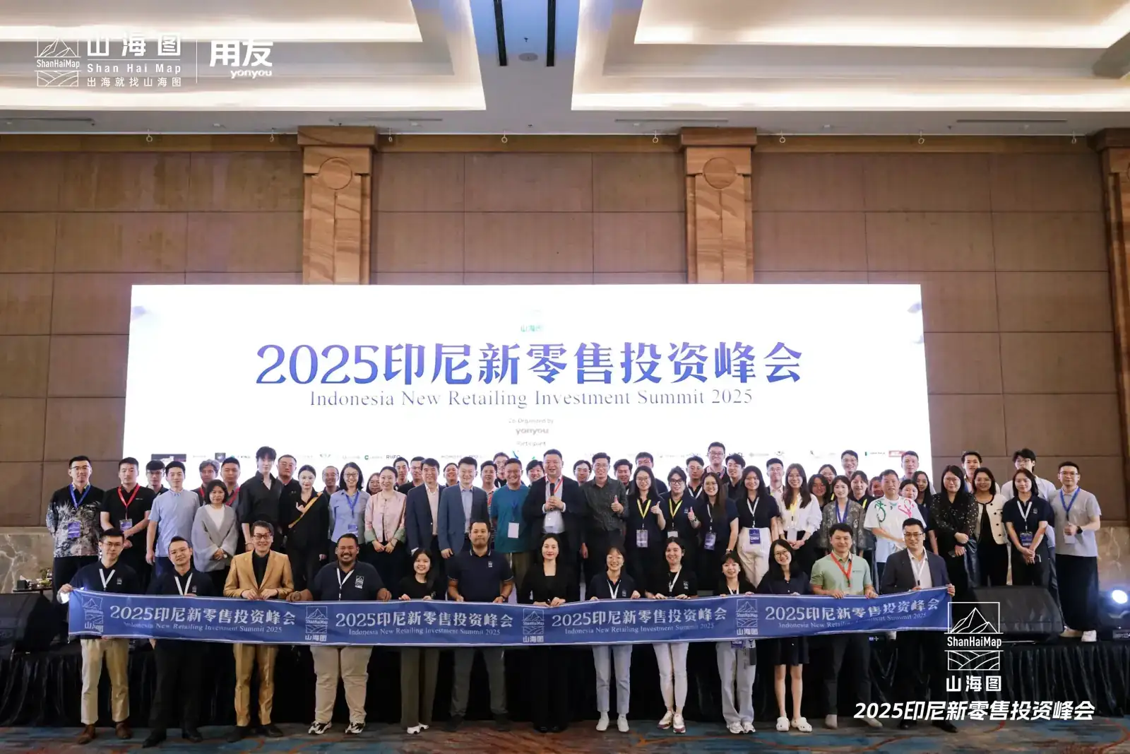 Large group of attendees holding an event banner at the Indonesia New Retailing Investment Summit 2025